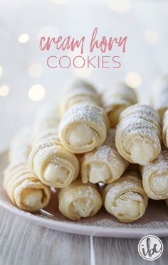 crepes filled with powdered sugar are on a white plate next to the words, cream born cookies