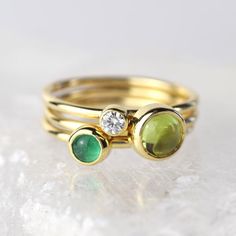 A stunning green peridot stacking ring made from solid 9ct yellow gold. Choose to wear the ring on its own, or mix and match it with other stacking rings from the Nebula collection, or why not add a sparkling Andromeda diamond ring?Peridot is a beautiful juicy green gemstone and the birthstone of August. It is one of only a few stones to come in only one colour, a lovely olive green and is said to bring a wonderful year to whoever wears it. It's warm glowing colour is a reminder of summer and of Fine Jewelry Green Stackable Birthstone Rings, Fine Jewelry Green Birthstone Stackable Rings, Green Birthstone Stackable Rings, Green Rings With Bezel Setting For May Birthstone, Green Bezel Set Rings For May Birthstone, Green Stackable Rings For Anniversary In Fine Jewelry Style, Green Sapphire Stackable Ring For Gift, Green Sapphire Stackable Ring For Anniversary, Green Stackable Sapphire Ring Perfect For Gifts