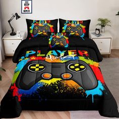 a bed covered in a black comforter with colorful video game controllers on the cover