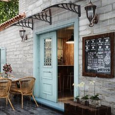 the outside of a restaurant with tables and chairs