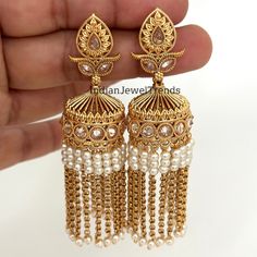 Long Gold Plated Polki Jhumka/Polki stone Jhumka/Indian Jewelry/Pakistani/Punjabi/Indian/Statement earring/Bridal earring/Indian wedding Antique Jhumkis With Gold Plating Height = 75 mm || Width = 28 mm Trendy Design Antique Earring Lightweight and elegant Can be paired with any dress Closure: Pushback This is 100% Handmade jewelry. So Color, shades, texture displayed may slightly vary from the actual product due to digital image limitations. We request you to consider these minor variations. Pl Kundan Jhumkas With Latkans For Celebrations, Celebration Kundan Jhumkas With Latkans, Bollywood Style Heavy Jhumkas For Celebration, Heavy Bollywood Jhumkas For Celebration, Traditional Pearl Earrings With Latkans And Dangle, Traditional Pearl Dangle Earrings With Latkans, Chandbali Bridal Earrings With Latkans For Festivals, Latkans Earrings For Wedding And Navratri, Bollywood Style Dangle Jhumkas With Latkans