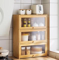 a wooden cabinet with glass doors in a kitchen