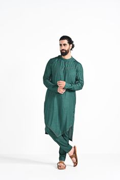 Bottle green criss cross jhaal embroidered on Modal silk with zari stitchline, pintuck and assymetrical hemline kurta. Paired with bottle green slim fit Pant Pajama. Color of the actual garment may vary due to lighting conditions during the shoot.
 

Size Chart For Men





	
	
					Men's Size Chart
		

		
		
						
				Size Chart For Men
				Custom Size Measurement Guide
			
			
				
				
				Custom Size Measurement Guide
1. Take your measurements at ease…don’t hold your breath!
2. Be a little Green Embroidered Cotton Silk Kurta, Embroidered Green Cotton Silk Kurta, Green Cotton Silk Sherwani With Zari Work, Green Chanderi Bandhgala With Cutdana, Designer Green Kurta With Cutdana, Green Cotton Silk Kurta With Chikankari Embroidery, Green Chanderi Sherwani For Eid, Fitted Green Chanderi Bandhgala, Fitted Green Bandhgala In Chanderi