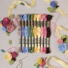 several skeins of thread with flowers and ribbons