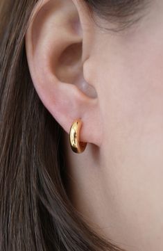 A chubby silhouette lends pillowy dimension to these dainty sterling silver hoop earrings plated in warm 18-karat gold. 5/8" hoop diameter; 1/4" width Hinge with snap-post closure Sterling silver/18k-gold plate Imported Gold Jewelry Earrings Studs, Everyday Gold Earrings Indian, Gold Everyday Earrings, Golden Studs Earrings, Small Gold Hoop Earrings Aesthetic, Simple Small Hoop Earrings, Classy Gold Earrings, Small Gold Earrings Designs, Gold Hoop Earrings Aesthetic