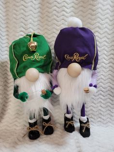 two small gnomes wearing green and purple outfits