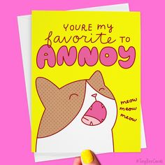 a hand holding up a card with an angry cat on it's face that says, you're my favorite to annoy