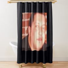 a shower curtain with an image of a man's face in the middle of it