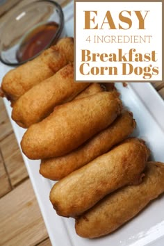 fried corn dogs on a white platter with dipping sauce in the background and text overlay that reads easy 4 ingredient breakfast corn dogs