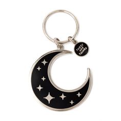 a black and white keychain with stars on the moon in the shape of a crescent