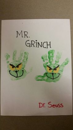 a sign with two handprints on it that says mr grinch and dr seuss