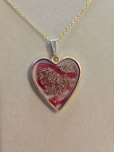 Pretty, heart shaped resin, pendant necklace with red and gold shimmer highlights set in a lead and nickel free bezel. You can choose between an 18" or 20" gold plated steel/iron chain.  Dimensions are approximate  Please message me here or email me at megrencreations@gmail.com if you have special requests, i.e.  if there is a piece you like - but maybe a different color, multiple pieces for a wedding, etc. Hypoallergenic Heart-shaped Jewelry For Valentine's Day, Valentine's Day Open Heart Keepsake Charm Necklace, Valentine's Day Keepsake Open Heart Charm Necklace, Nickel-free Heart Pendant Jewelry For Valentine's Day, Double Heart Charm Necklaces For Valentine's Day Keepsake, Nickel-free Round Heart Necklace For Valentine's Day, Gold Heart Necklace Nickel Free, Gold Hypoallergenic Heart Necklace As Gift, Nickel-free Heart Necklace For Valentine's Day Keepsake