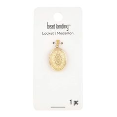 a small gold medallion with the word bead landing on it's front side