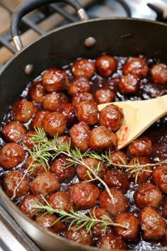 a pan filled with meatballs on top of a stove