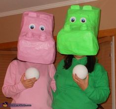 two people in costumes holding balls and bags