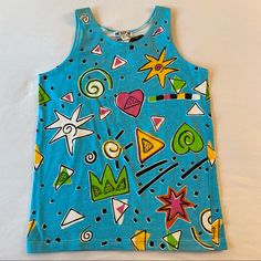 Vibrant & Cheerful New W Tags Size Medium 25.5” Shoulder To Hem / 36” Bust Prewashed / Ready To Wear Buying More Than 1 , Dm Me To Bundle Shipping Funky Tank Tops, Blue 90s Style Tank Top For Summer, 90s Style Blue Tank Top For Summer, Blue Cotton Top With Colorful Pattern, Blue Cotton Tops With Colorful Pattern, 90s Style Blue Sleeveless Tops, Blue Tops With Colorful Pattern For Summer, Blue Playful Tank Top, Blue Graphic Print Tank Top For Spring