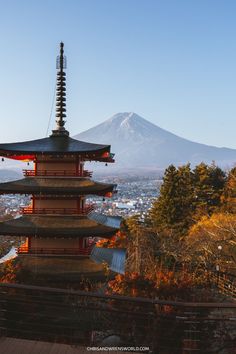 a tall pagoda with a mountain in the background