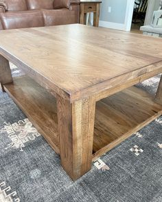 a wooden coffee table sitting on top of a rug