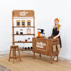 a woman standing behind a coffee shop counter