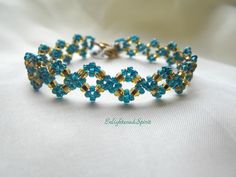 How cute is this bracelet?? It`s simple but eye catching with it`s intricate pattern. Great match to all your holiday outfits. Made with gold and gorgeous rainbow teal seed beads and very strong beading material.  Fits about 6.5 ìn and the toggle clasp ensures it will stay securely on your wrist.  This item is already made and ready to ship. ஐ ¸.**'¯) ஐ ¸.**'¯) ஐ ♥ All items handmade in beautiful Nova Scotia, Canada ♥ ** To check out other handmade designs in my shop: http://www.etsy.com/shop/EnlightenedSpirit ** Payment & shipping policy:  http://www.etsy.com/shop/EnlightenedSpirit/policy ** Questions? Don't hesitate to convo me! http://www.etsy.com/conversations/new?with_id=5081355 ஐ Thank you for choosing Handmade! Elegant Blue Beaded Crystal Bracelet, Turquoise Jubilee Bracelet Jewelry Gift, Handmade Light Blue Jewelry For Party, Elegant Handmade Light Blue Beaded Bracelets, Blue Round Bead Bracelets For Weddings, Light Blue Bracelet For Party, Elegant Turquoise Beaded Bracelets As Gift, Blue Round Beads Bracelet For Wedding, Light Blue Bangle Jewelry Gift