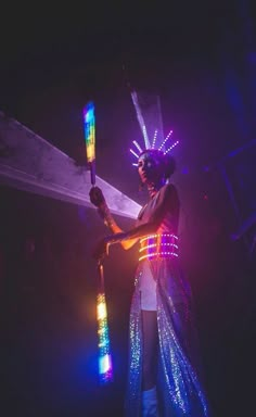 a woman in costume holding a lighted stick