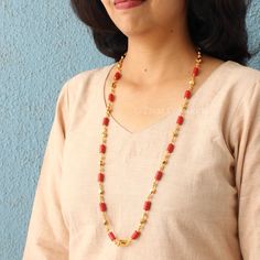 A typical coral-colored South Indian Laxmi pendant design featuring coral beads and gold-polished beads and chain with a high gold polish. A beautiful selection for all occasions, handmade with perfection. Match this jewelry with any of your outfits and flaunt your style. Length - 28 inches. Coral Long Chain Gold, Red 22k Gold Temple Necklace For Celebration, Red 22k Gold Necklace For Festivals, Red 22k Gold Necklace For Celebration, Festive 22k Gold Red Necklaces, Festive Red 22k Gold Necklaces, Festive Red 22k Gold Necklace, Red 22k Gold Temple Jewelry Necklace, Handmade Gold Necklace With Red Coral