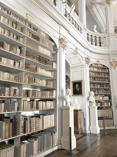 a large room filled with lots of books on top of shelves next to a staircase