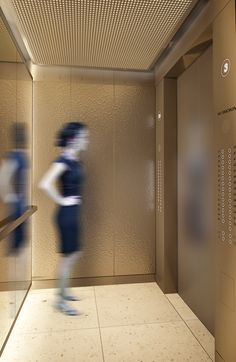 a blurry photo of a person walking down the stairs in a building with elevators