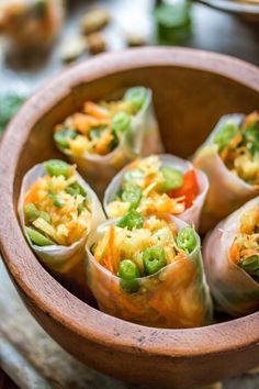 a wooden bowl filled with food on top of a table