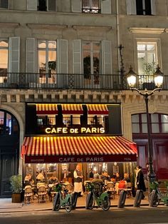 the cafe de paris is lit up at night