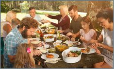 a group of people sitting around a table eating food