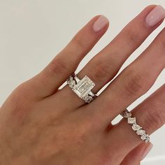 a woman's hand with two rings on it and one ring in the middle