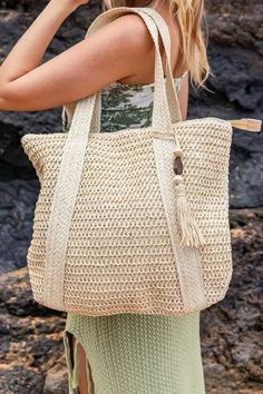 Straw Tote An essential for any beachy getaway or sunny holiday (I can already feel the sun on my face), this straw tote bag is a must-have for all your summer adventures. With ample interior space, you can easily carry all your beach essentials (and maybe a souvenir or two) in this stylish tote. Say goodbye to boring and bulky bags, and hello to this trendy and functional tote that is sure to turn heads wherever you go. Product Description\ Woven Straw Exterior Wooden Bead/Straw Tassel AccentHa Sunny Holiday, Straw Beach Bag, Straw Tote Bag, Swim Shoes, Tassel Bag, Straw Tote, Beach Essentials, Summer Adventures, Swimwear Outfit