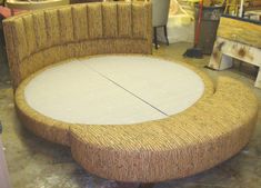 a couch made out of wicker sitting on top of a wooden table in a room