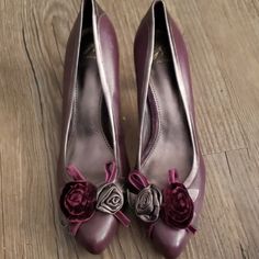 J. Vincent Brand High Heels In Size 9½. They Are New Without Tags, And In Absolutely Beautiful Condition! The Color Is Deep Plum, With A Dark/Deep Bronze/Gray Line Around The Top And Down The Back. One Flower On The Toe Is Velvet, The Other Leather. Really, Really Pretty Shoes! Purple High Heels For Formal Occasions, Purple Pointed Toe Heels For Formal Occasions, Elegant Purple 4-inch Heels, Chic Purple Heels For Formal Occasions, Chic Purple Heels For Formal Events, Elegant Purple Heels For Formal Occasions, Purple Heels For Spring Formal, Purple Spring Formal Heels, Spring Formal Purple Heels