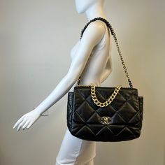 Chanel Maxi 19 Flap Bag with Bi-colored Chain Link Shoulder Strap, Interlocking CC Logo and Quilted Pattern (includes Dustbag) Designer = Chanel Color = Black Material = Lamb Skin Condition = Excellent Height = 10 Width = 14 Depth = 4.5" Class = Premier Location: Wilmette Item Number: 20201-73 Item ID: 300893 Category: Shoulder Bag High-end Shoulder Bag With Chain Strap For Travel, Evening Tote Shoulder Bag With Cc Turnlock Closure, Luxury Chain Crossbody Bag, Designer Flap Shoulder Bag With Chain Strap, Designer Shoulder Flap Bag With Chain Strap, Designer Shoulder Bag With Chain For Travel, Designer Chain Shoulder Bag For Travel, Everyday Luxury Rectangular Bag With Chain, Luxury Everyday Rectangular Bag With Chain