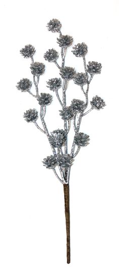 a metal tree with lots of leaves on it's branches, against a white background