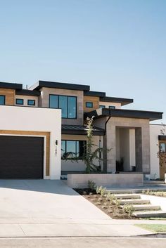 the front and back side of a house with two garages on each side, one is