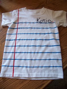 a white t - shirt with blue and red lines on it that says, kate