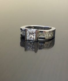 DeKara Designs Collection Metal- 90% Platinum, 10% Iridium, 5.60 Grams.Stones- EGL Certified Center Princess Cut Diamond, F Color VS2 Clarity 1.03 Carats, Side Stones 8 Princess Cut Diamonds F-G Color VS2 Clarity 0.80 Carats.  Size- 4.  FREE SIZING!!!!Ring Comes With EGL USA Certificate, and Diamond Appraisal.  Can be made in your specific size within 5-7 working days.  A Classic and Timeless Modern Diamond Platinum Engagement Ring.  This ring is entirely handmade! The center diamond is a beauti 14k White Gold Jewelry With Princess Cut Center Stone, Modern Promise Ring With Vs Clarity, Timeless White Ring For Anniversary, Heirloom White Diamond Ring With Vs Clarity, Timeless White Rings For Anniversary, Heirloom White Diamond Ring Vs Clarity, Timeless Princess Cut Diamond Ring With Vs Clarity, Luxury Anniversary Ring With Channel Set, Luxury Jewelry With Emerald Cut And Channel Set