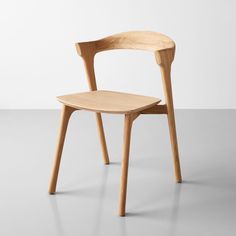 a wooden chair sitting on top of a white floor