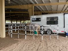 a horse trailer is parked in the sand