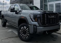 a gray truck parked in front of a building