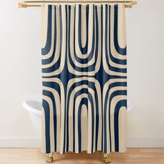 a blue and white shower curtain with an abstract design on the outside, in front of a bathtub