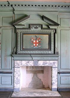 an old fireplace in a room with green walls