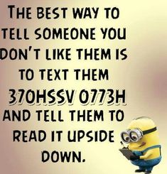 a minion sitting on top of a table next to a quote