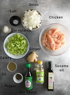 ingredients to make chicken broth laid out in bowls on a gray surface, including onions, celery, seasoning, salt, and mayo