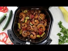 shrimp and vegetables cooking in an air fryer