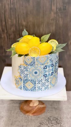 a blue and white cake with lemons on top