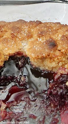 a close up of a piece of food in a pan with blueberry sauce on it